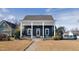 Charming home featuring blue siding, white trim, and a covered porch with a small garden in the front yard at 27 Ellen Cir, Clayton, NC 27527