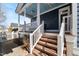 Charming front porch showing the wooden stairs leading up to the entrance and lovely blue ceiling at 27 Ellen Cir, Clayton, NC 27527