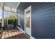 View of the front porch with light blue ceiling, home number and bench, surrounded by lush greenery at 27 Ellen Cir, Clayton, NC 27527