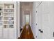 Hallway with hardwood floors, built-in shelving, and access to multiple rooms at 27 Ellen Cir, Clayton, NC 27527