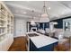 Open concept kitchen island with cooktop overlooks the living room with fireplace at 27 Ellen Cir, Clayton, NC 27527
