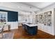 Well-lit kitchen featuring a large island with seating, stylish pendant lighting, and built-in bookshelves at 27 Ellen Cir, Clayton, NC 27527