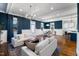 Inviting living room features an open floor plan, hardwood floors, white couches and a kitchen with a bar at 27 Ellen Cir, Clayton, NC 27527