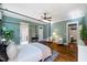 Spacious main bedroom offers hardwood floors, seating area, canopy bed, and ensuite bath access at 27 Ellen Cir, Clayton, NC 27527