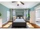 Well-lit main bedroom with hardwood floors, a canopy bed, and ensuite bathroom with freestanding tub at 27 Ellen Cir, Clayton, NC 27527