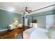 Inviting main bedroom with hardwood floors, a canopy bed, seating area, and ensuite bathroom access at 27 Ellen Cir, Clayton, NC 27527