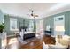 Bright main bedroom features a canopy bed, hardwood floors, and a doorway leading to the ensuite bath at 27 Ellen Cir, Clayton, NC 27527