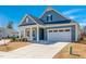 Beautiful home featuring blue siding, a well-maintained lawn, and a two-car garage at 276 Bevis Marks Dr, Fuquay Varina, NC 27526