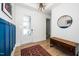 Entryway featuring hardwood floors, a stylish light fixture, and a decorative mirror and bench at 276 Bevis Marks Dr, Fuquay Varina, NC 27526