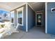 Inviting front porch with seating, offering a relaxing outdoor space with views of the neighborhood at 276 Bevis Marks Dr, Fuquay Varina, NC 27526