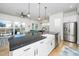Bright, open-concept kitchen with a large island, stainless steel appliances, and an adjacent living area at 276 Bevis Marks Dr, Fuquay Varina, NC 27526