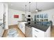 Spacious kitchen with dark countertops, a white farmhouse sink, and stainless steel appliances at 276 Bevis Marks Dr, Fuquay Varina, NC 27526