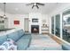 Cozy living room with a fireplace, comfortable seating, and sliding doors to the backyard at 276 Bevis Marks Dr, Fuquay Varina, NC 27526