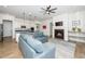 Open-concept living room with fireplace and modern kitchen featuring stainless steel appliances at 276 Bevis Marks Dr, Fuquay Varina, NC 27526