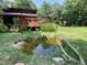 The backyard features a raised deck and landscaped pond, offering a peaceful retreat at 279 Box Turtle Trl, Chapel Hill, NC 27516