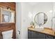 This bathroom features a wood vanity, a white vessel sink, and a decorative mirror at 279 Box Turtle Trl, Chapel Hill, NC 27516