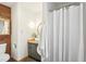 Modern bathroom featuring stylish vanity, round mirror, and a tub with shower curtain at 279 Box Turtle Trl, Chapel Hill, NC 27516