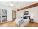 Bright bedroom features wood floors, exposed beam, and a walkout to the porch at 279 Box Turtle Trl, Chapel Hill, NC 27516