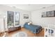 Cozy bedroom with natural light, wood floors, stylish decor, and a view of the outdoors at 279 Box Turtle Trl, Chapel Hill, NC 27516