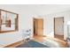 Bright bedroom with wood floors, large windows, and a glimpse into an adjoining room at 279 Box Turtle Trl, Chapel Hill, NC 27516