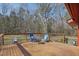 Outdoor deck featuring blue Adirondack chairs and peaceful wooded views at 279 Box Turtle Trl, Chapel Hill, NC 27516