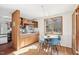 Bright dining area with wood floors and a table set for four near a sunny window at 279 Box Turtle Trl, Chapel Hill, NC 27516