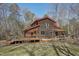 Exterior elevation showing a rustic wood cabin featuring a large deck perfect for outdoor living at 279 Box Turtle Trl, Chapel Hill, NC 27516