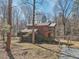 Wood cabin home surrounded by trees featuring a screened in porch and front deck at 279 Box Turtle Trl, Chapel Hill, NC 27516