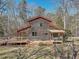 Rustic home showcasing its exterior with a large deck at 279 Box Turtle Trl, Chapel Hill, NC 27516