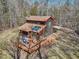 Aerial view of home featuring an expansive deck and wooded surroundings at 279 Box Turtle Trl, Chapel Hill, NC 27516