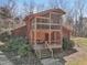Cabin-style home with a screened porch and deck, surrounded by lush greenery at 279 Box Turtle Trl, Chapel Hill, NC 27516