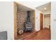 Close-up of a brick fireplace with a wood-burning stove and rustic details at 279 Box Turtle Trl, Chapel Hill, NC 27516