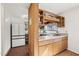 This open kitchen features light countertops, wood cabinets, and a unique shelving and window design at 279 Box Turtle Trl, Chapel Hill, NC 27516