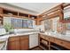This eat-in kitchen features bright countertops, wood cabinets, and an adjacent window offering wooded views at 279 Box Turtle Trl, Chapel Hill, NC 27516