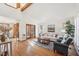 Bright living room with hardwood floors, a comfortable sofa, and natural light from large windows at 279 Box Turtle Trl, Chapel Hill, NC 27516
