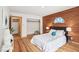 Bedroom boasts hardwood floors, a wood accent wall, a walk-in closet, and an ensuite bathroom at 279 Box Turtle Trl, Chapel Hill, NC 27516
