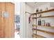 The pantry features rustic wood shelving, storage jars, and a view to the dining area at 279 Box Turtle Trl, Chapel Hill, NC 27516