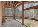 Enclosed porch features exposed beams and a lovely view of the wooded backyard at 279 Box Turtle Trl, Chapel Hill, NC 27516