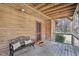 Inviting porch featuring wood walls, a cozy bench, and a rustic wooden ceiling at 279 Box Turtle Trl, Chapel Hill, NC 27516