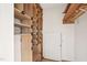 Organized storage space with custom built-in shelving and a closed door for additional storage at 279 Box Turtle Trl, Chapel Hill, NC 27516