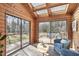 Bright sunroom features skylights, brick floors, and sliding glass doors to a deck and wooded view at 279 Box Turtle Trl, Chapel Hill, NC 27516