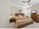 Bedroom features a large ceiling fan, dresser, and comfortable decor at 2851 Wilkes Lake Dr, Fuquay Varina, NC 27526