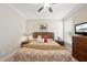 Comfortable bedroom featuring soft lighting, ceiling fan, and a flat-screen TV at 2851 Wilkes Lake Dr, Fuquay Varina, NC 27526