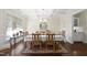Formal dining room featuring elegant chandelier, trey ceiling and a large window, perfect for entertaining at 2851 Wilkes Lake Dr, Fuquay Varina, NC 27526