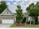 Charming single-story home featuring a two-car garage and beautifully landscaped front yard with colorful flower beds at 2851 Wilkes Lake Dr, Fuquay Varina, NC 27526