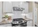 Updated kitchen features tile backsplash, granite counters, stainless appliances, and ample storage at 2851 Wilkes Lake Dr, Fuquay Varina, NC 27526
