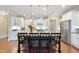 Kitchen with large island and seating opens to the living area, featuring stainless appliances at 2851 Wilkes Lake Dr, Fuquay Varina, NC 27526