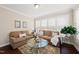 Inviting living room with abundant natural light, plush seating, and elegant decor at 2851 Wilkes Lake Dr, Fuquay Varina, NC 27526
