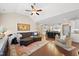 Open floor plan with living room with fireplace, hardwood floors and large kitchen with island and bar seating at 2851 Wilkes Lake Dr, Fuquay Varina, NC 27526