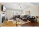 Bright living room featuring a fireplace, large windows, hardwood floors, and comfortable seating at 2851 Wilkes Lake Dr, Fuquay Varina, NC 27526